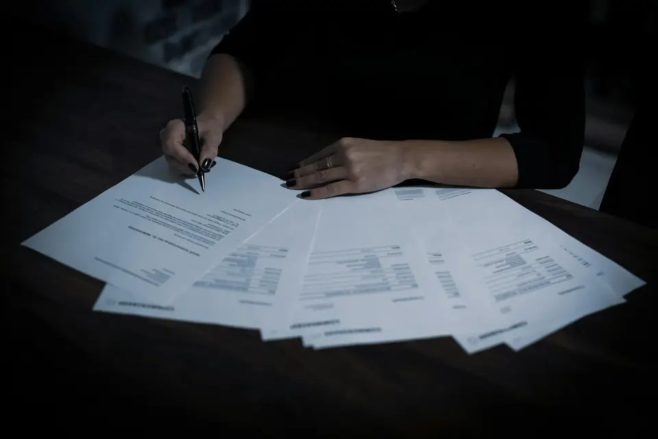 Person reviewing and signing loan application documents
