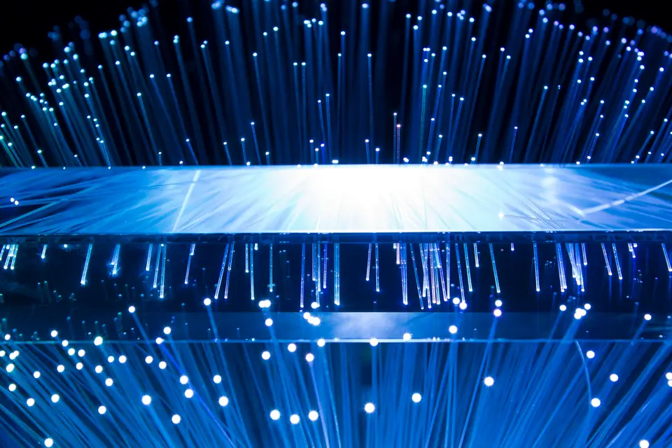 Fibre-optic strands carrying points of blue light