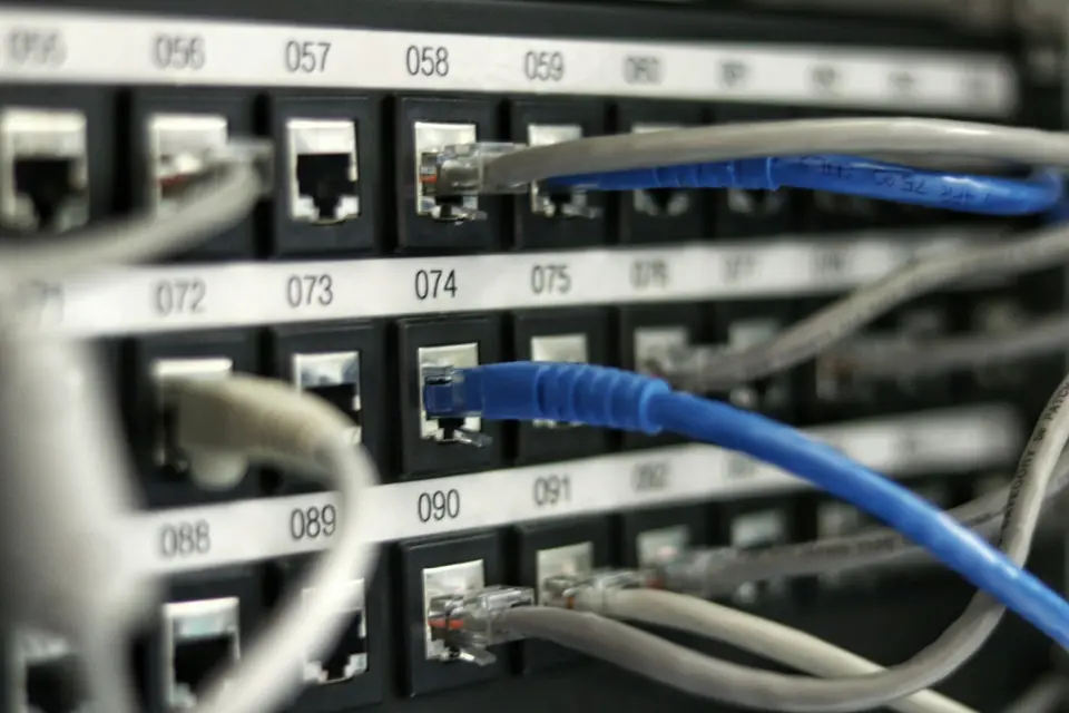 Network patch panel with cables plugged into numbered ports